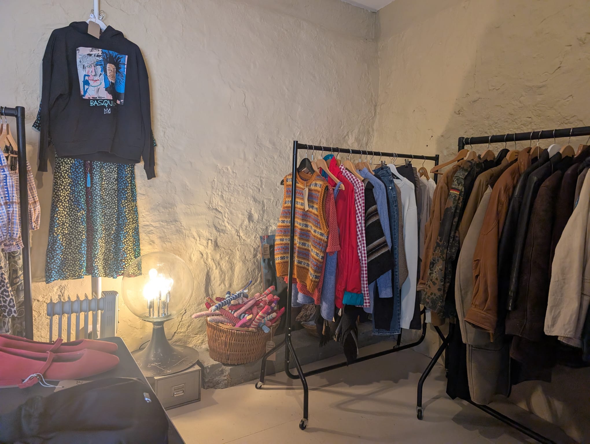 A Basquiat hoodie hung on the wall, with knits, leather jackets and oddities on the rails behind