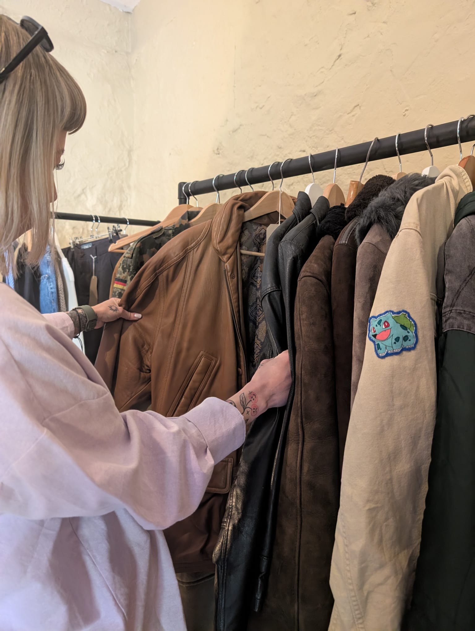 A customer browsing the rail of leather and sheepskin coats