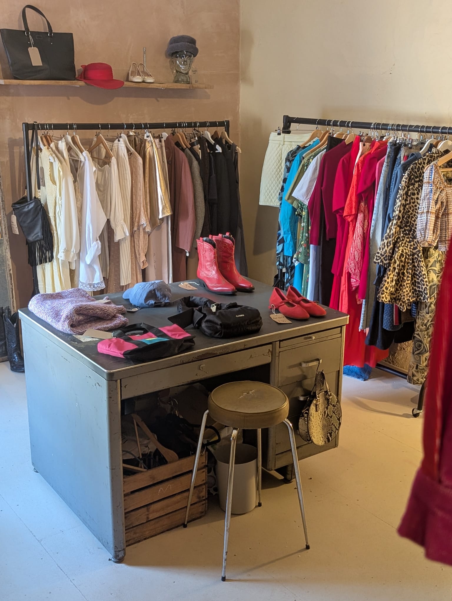 Beetle Eyes — two clothing rails flanking a central desk with bags, scarves and red ankle boots