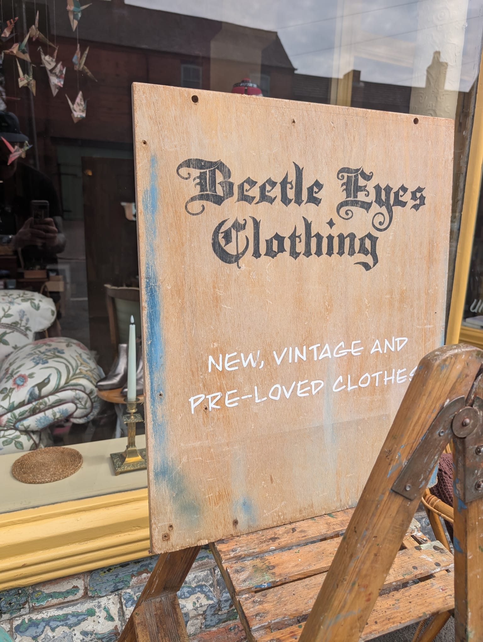 Hand-painted Beetle Eyes Clothing wooden sign reading 'New, vintage and pre-loved clothes'
