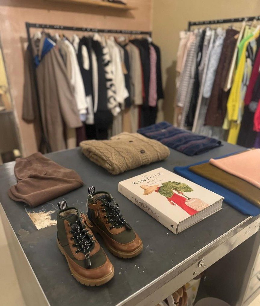 Beetle Eyes clothing rail with knitwear and walking boots
